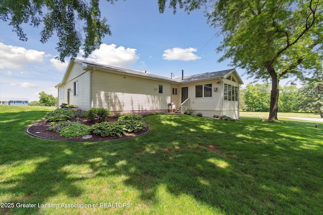 6252 N River Hwy, Grand Ledge, MI 48837 - back of house featuring entry steps and a yard
