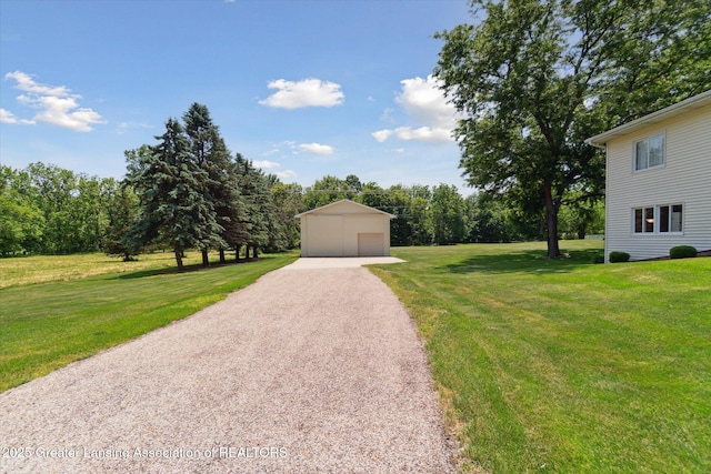 6252 N River Hwy, Grand Ledge, MI 48837 - view of front of house with a garage, a front yard, and an outbuilding