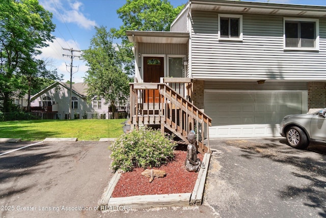 5041 E Willoughby Rd Unit 7, Holt, MI 48842 - view of front facade featuring a garage, a front lawn, and driveway