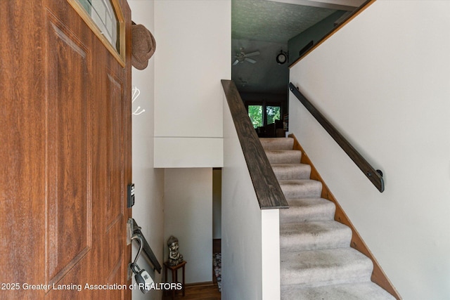 5041 E Willoughby Rd Unit 7, Holt, MI 48842 - stairway featuring a ceiling fan