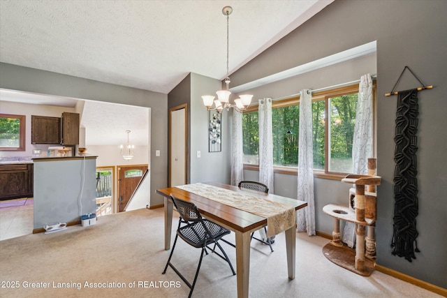 5041 E Willoughby Rd Unit 7, Holt, MI 48842 - dining area with a chandelier, healthy amount of natural light, light colored carpet, lofted ceiling, and a textured ceiling