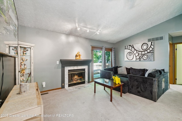 5041 E Willoughby Rd Unit 7, Holt, MI 48842 - living area with carpet floors, a textured ceiling, a premium fireplace, and rail lighting