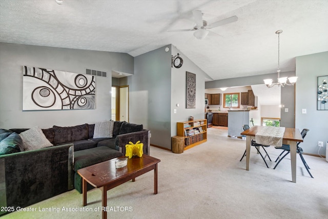 5041 E Willoughby Rd Unit 7, Holt, MI 48842 - living area with vaulted ceiling, a chandelier, light carpet, a ceiling fan, and a textured ceiling