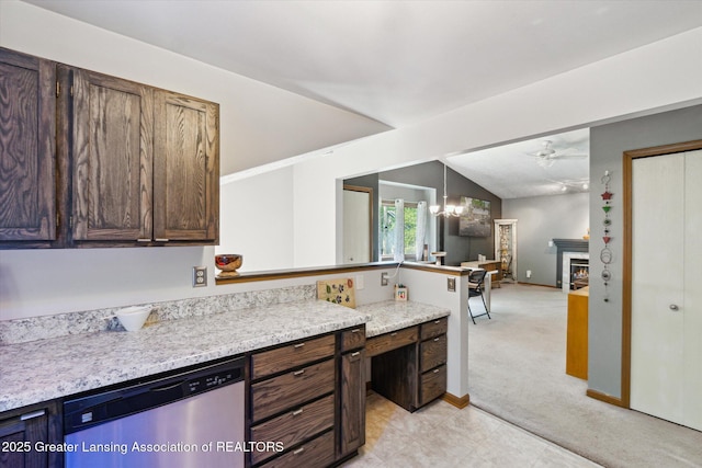 5041 E Willoughby Rd Unit 7, Holt, MI 48842 - kitchen with dishwasher, light countertops, light carpet, ceiling fan, and a lit fireplace