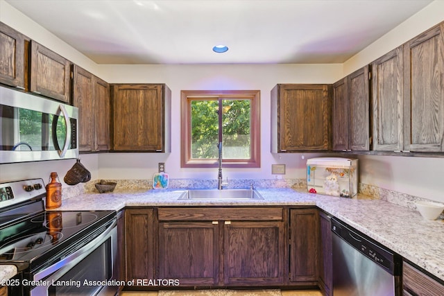 5041 E Willoughby Rd Unit 7, Holt, MI 48842 - kitchen featuring appliances with stainless steel finishes and dark brown cabinetry