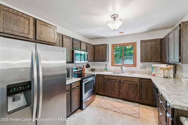 5041 E Willoughby Rd Unit 7, Holt, MI 48842 - kitchen with appliances with stainless steel finishes, light countertops, and dark brown cabinetry