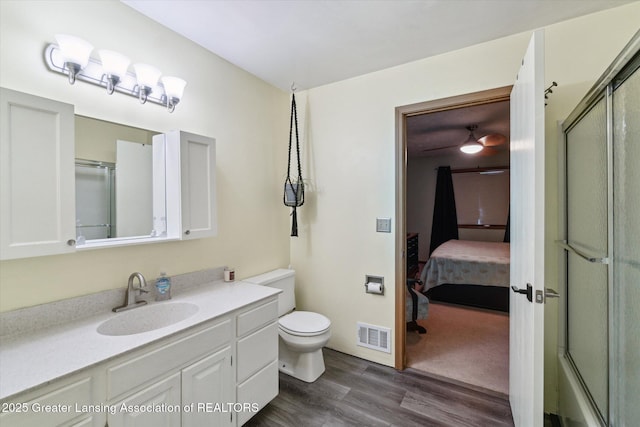 5041 E Willoughby Rd Unit 7, Holt, MI 48842 - bathroom with ensuite bathroom, a shower with door, wood finished floors, and vanity