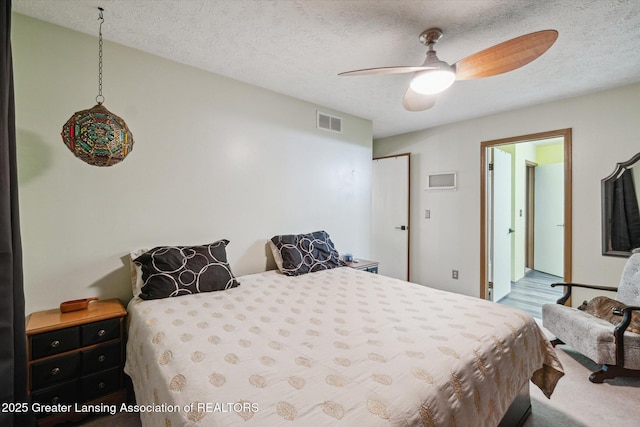 5041 E Willoughby Rd Unit 7, Holt, MI 48842 - bedroom with a textured ceiling and ceiling fan