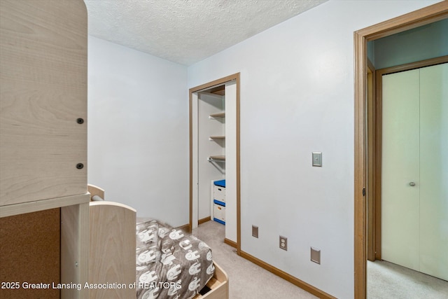 5041 E Willoughby Rd Unit 7, Holt, MI 48842 - bedroom featuring light carpet and a textured ceiling
