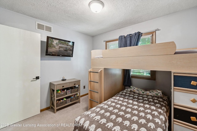 5041 E Willoughby Rd Unit 7, Holt, MI 48842 - carpeted bedroom with a textured ceiling and multiple windows