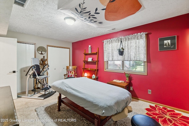 5041 E Willoughby Rd Unit 7, Holt, MI 48842 - carpeted bedroom featuring multiple closets and a textured ceiling