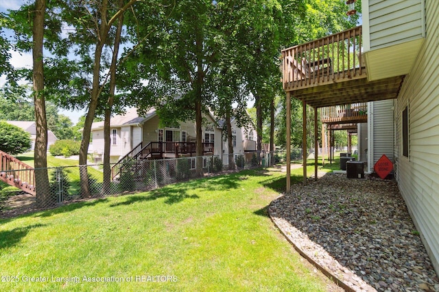 5041 E Willoughby Rd Unit 7, Holt, MI 48842 - fenced backyard with a wooden deck and stairs