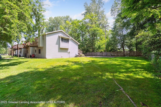 5041 E Willoughby Rd Unit 7, Holt, MI 48842 - fenced backyard with a deck