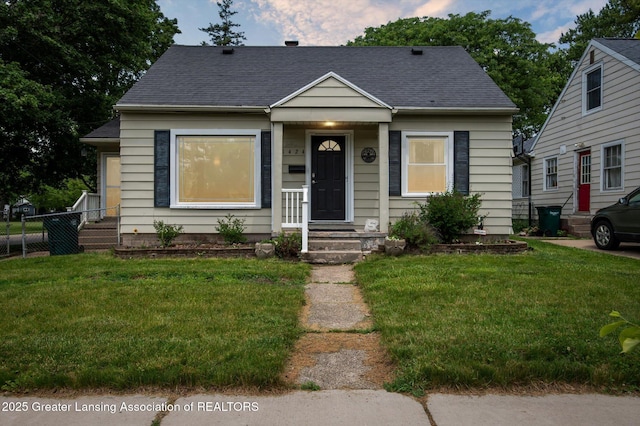 1424 Woodbine Ave, Lansing, MI 48910 - bungalow featuring roof with shingles