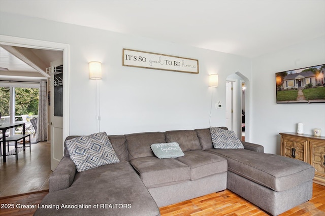 1424 Woodbine Ave, Lansing, MI 48910 - living room with arched walkways and light wood finished floors