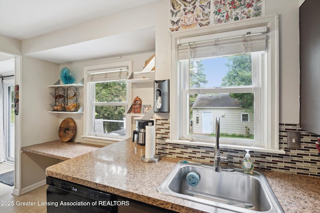 1424 Woodbine Ave, Lansing, MI 48910 - kitchen featuring dishwasher, backsplash, and light countertops