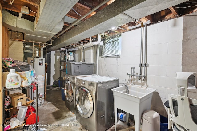 1424 Woodbine Ave, Lansing, MI 48910 - washroom featuring water heater and washing machine and clothes dryer