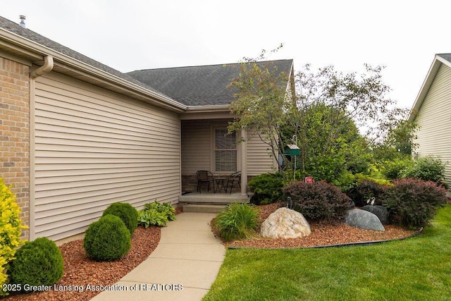 4001 Sierra Hts, Holt, MI 48842 - entrance to property featuring a shingled roof and brick siding