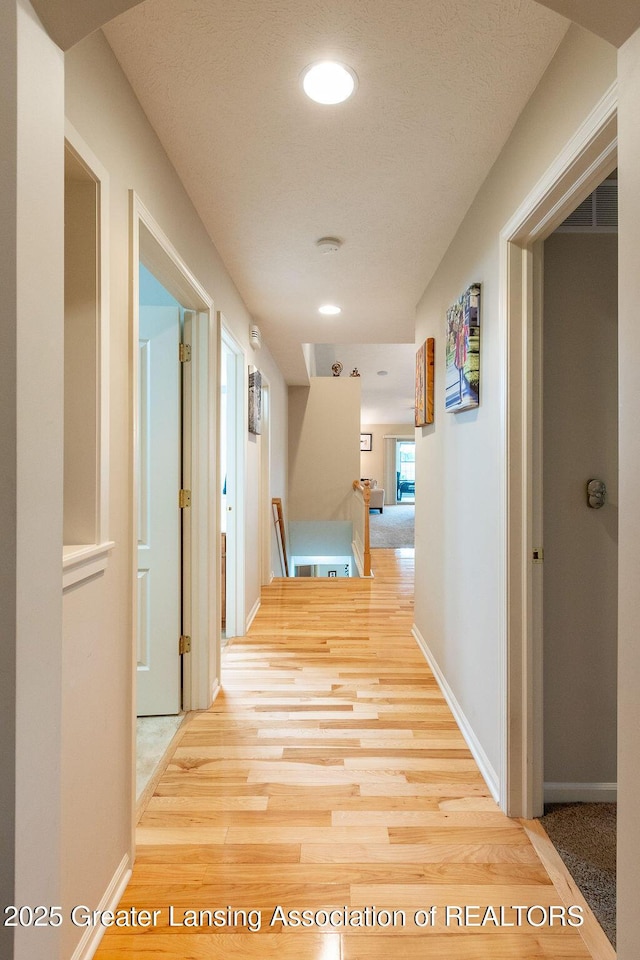 4001 Sierra Hts, Holt, MI 48842 - hallway featuring wood finished floors, recessed lighting, and a textured ceiling