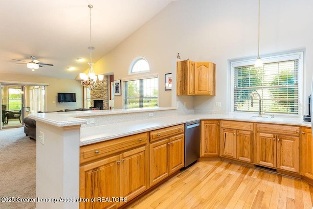 4001 Sierra Hts, Holt, MI 48842 - kitchen featuring high vaulted ceiling, dishwasher, light countertops, a peninsula, and a fireplace