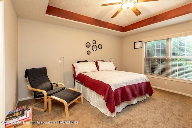 4001 Sierra Hts, Holt, MI 48842 - carpeted bedroom with a raised ceiling and a ceiling fan
