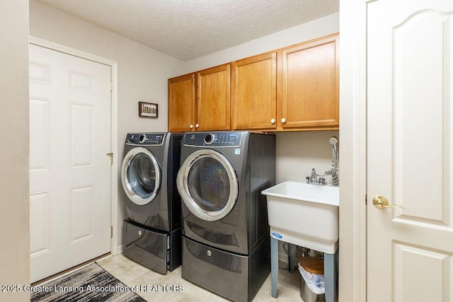 4001 Sierra Hts, Holt, MI 48842 - laundry room featuring cabinet space, washer and dryer, and a textured ceiling