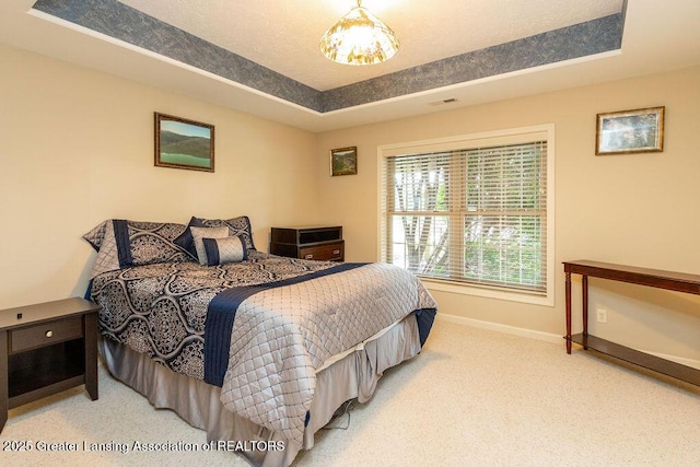 4001 Sierra Hts, Holt, MI 48842 - carpeted bedroom featuring baseboards and a tray ceiling