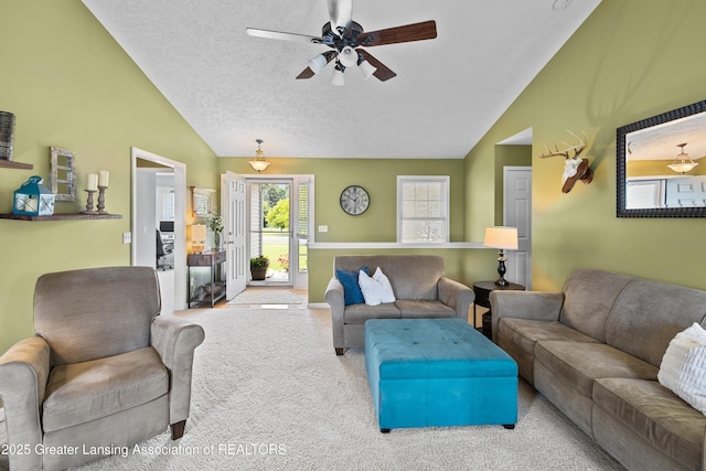 3913 Danbridge Dr, Lansing, MI 48906 - carpeted living room with lofted ceiling, a ceiling fan, and a textured ceiling