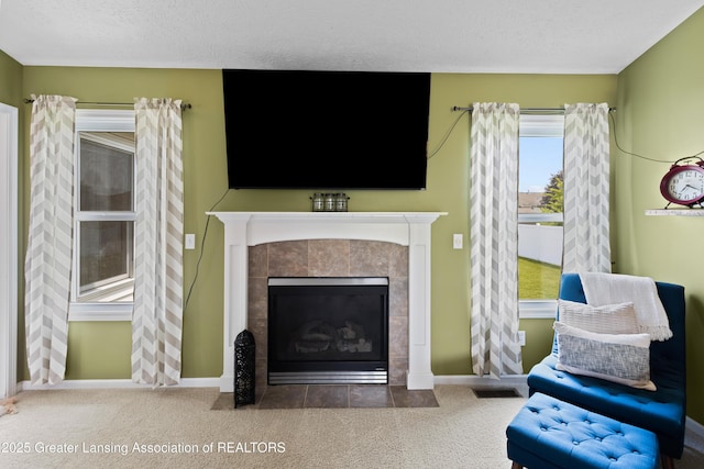 3913 Danbridge Dr, Lansing, MI 48906 - carpeted living room with a tiled fireplace and a textured ceiling