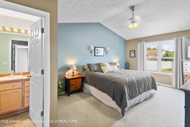 3913 Danbridge Dr, Lansing, MI 48906 - bedroom with lofted ceiling, light colored carpet, a textured ceiling, and ensuite bathroom