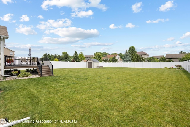 3913 Danbridge Dr, Lansing, MI 48906 - fenced backyard with a storage unit, a wooden deck, and stairs