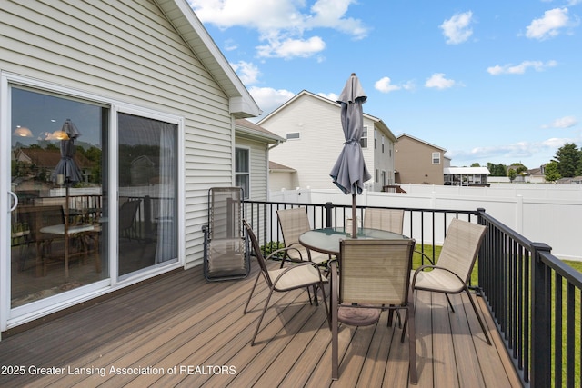 3913 Danbridge Dr, Lansing, MI 48906 - wooden deck with outdoor dining space and a fenced backyard