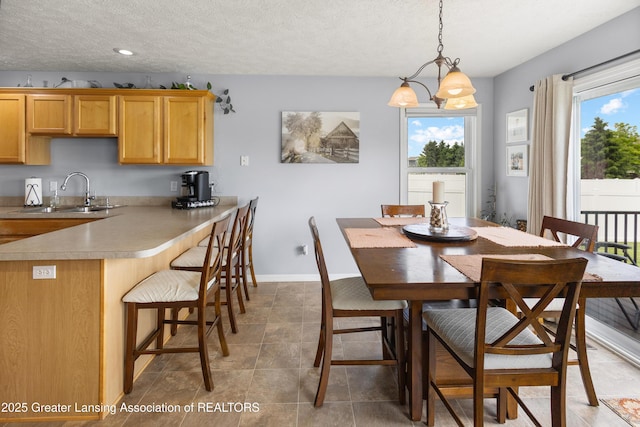 3913 Danbridge Dr, Lansing, MI 48906 - dining room with a textured ceiling, recessed lighting, light tile patterned flooring, and a chandelier