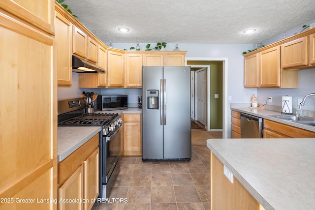 3913 Danbridge Dr, Lansing, MI 48906 - kitchen featuring stainless steel appliances, under cabinet range hood, light brown cabinetry, light countertops, and a textured ceiling