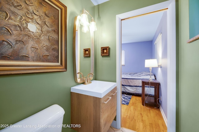 425 S Holmes St, Lansing, MI 48912 - ensuite bathroom featuring vanity and wood finished floors