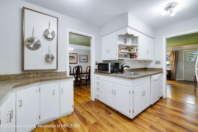 425 S Holmes St, Lansing, MI 48912 - kitchen featuring stainless steel microwave, white dishwasher, open shelves, decorative backsplash, and white cabinets