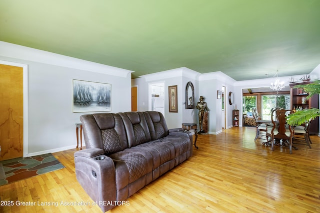 425 S Holmes St, Lansing, MI 48912 - living room featuring a chandelier and light wood-style floors