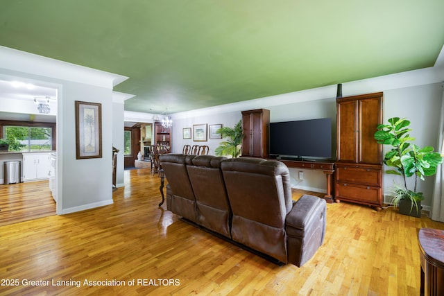 425 S Holmes St, Lansing, MI 48912 - living area featuring a chandelier and light wood-type flooring
