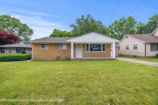 425 S Holmes St, Lansing, MI 48912 - view of front of home with brick siding, a front lawn, concrete driveway, and a garage