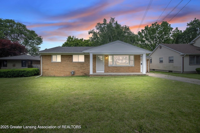 425 S Holmes St, Lansing, MI 48912 - view of front facade with a front lawn, brick siding, and concrete driveway