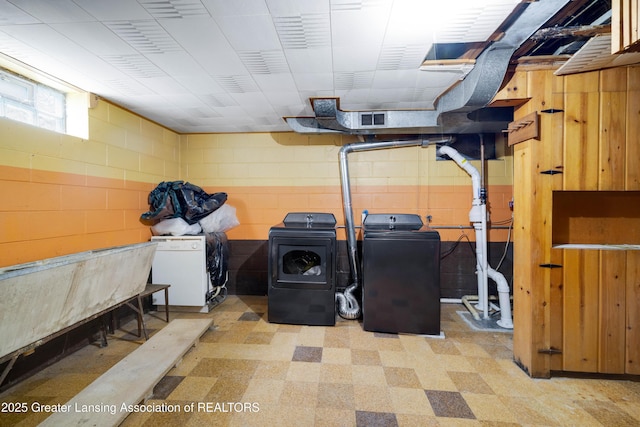 425 S Holmes St, Lansing, MI 48912 - washroom with separate washer and dryer, tile patterned floors, and concrete block wall