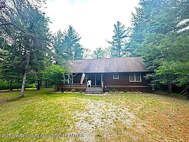 10886 SE Gillow Rd, Fife Lake, MI 49633 - view of front of property with a front lawn and a deck