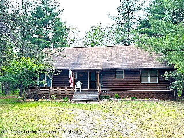 10886 SE Gillow Rd, Fife Lake, MI 49633 - view of front of property with a front lawn and log siding