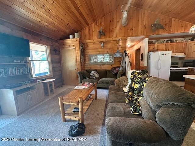 10886 SE Gillow Rd, Fife Lake, MI 49633 - living area featuring lofted ceiling, light carpet, wooden ceiling, and wooden walls
