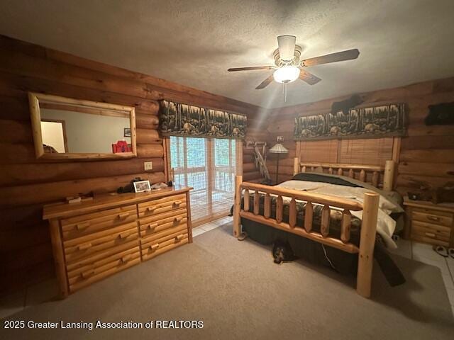 10886 SE Gillow Rd, Fife Lake, MI 49633 - bedroom featuring log walls, carpet floors, and a ceiling fan