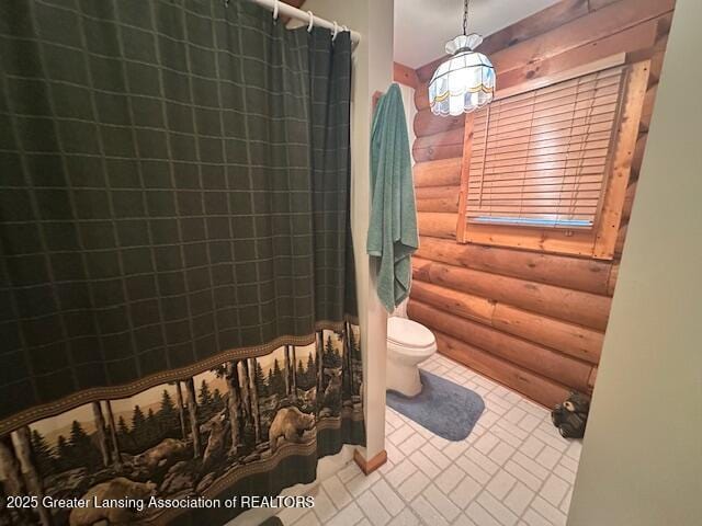10886 SE Gillow Rd, Fife Lake, MI 49633 - full bath featuring log walls and curtained shower