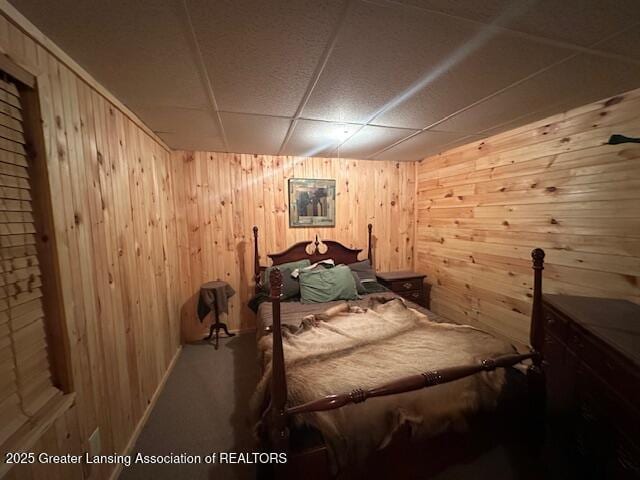 10886 SE Gillow Rd, Fife Lake, MI 49633 - bedroom featuring wood walls, a paneled ceiling, and carpet flooring
