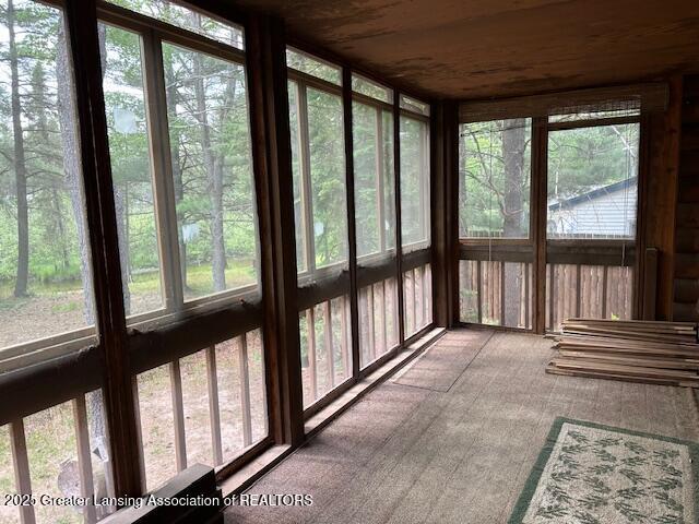10886 SE Gillow Rd, Fife Lake, MI 49633 - unfurnished sunroom with carpet and wood ceiling