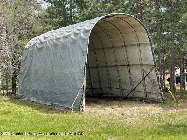 10886 SE Gillow Rd, Fife Lake, MI 49633 - view of outdoor structure with a detached carport