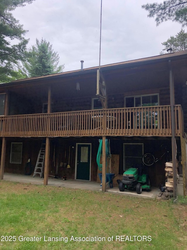 10886 SE Gillow Rd, Fife Lake, MI 49633 - rear view of property featuring stairs, a wooden deck, and a patio area